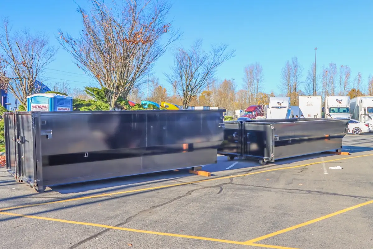 Professional dumpster rental service with roll-off container on residential driveway in Fruita